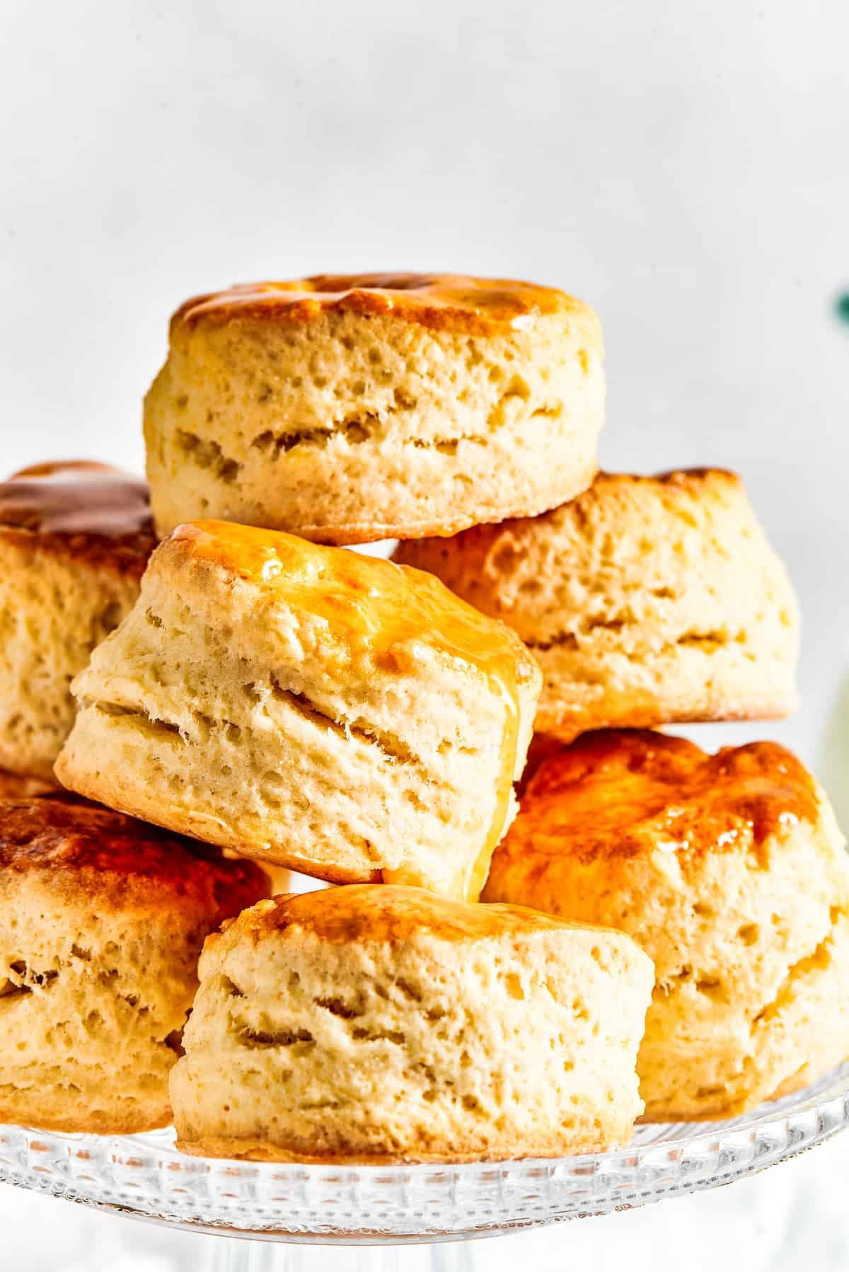 Six biscuits, stacked in a pyramid shape on a cake plate.