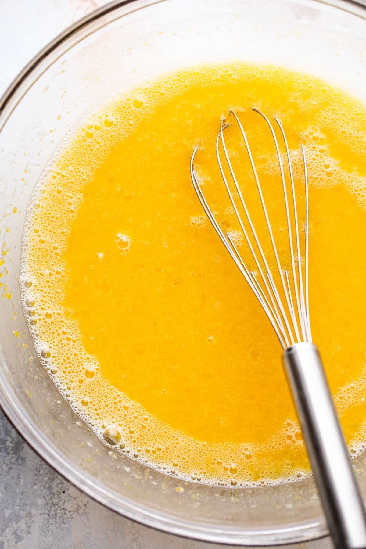 mixing bowl filled with egg and lemon juice batter for lemon bars
