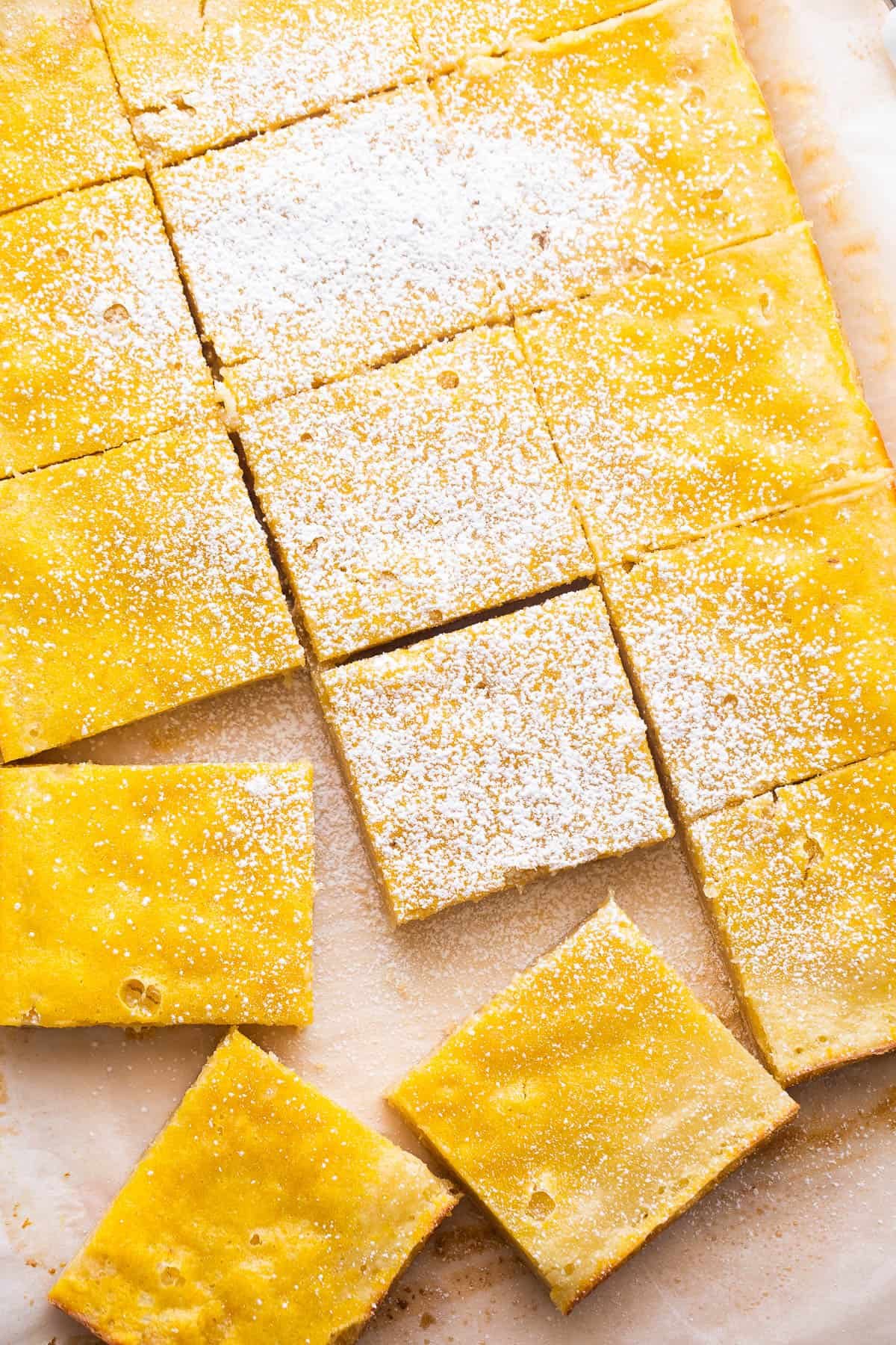 overhead shot of cut lemon squares dusted with powdered sugar