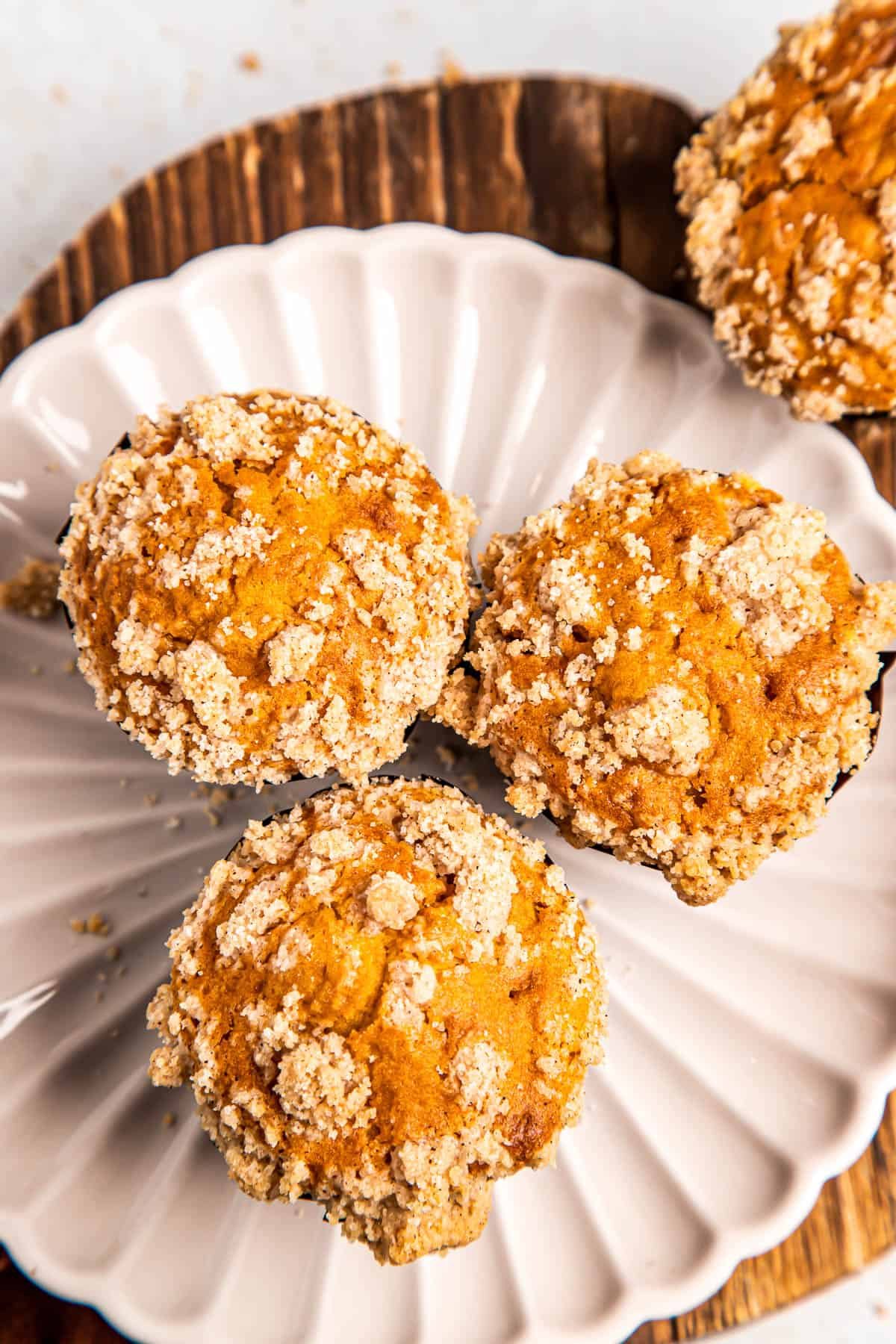 overhead shot of three pumpkin muffins on a white plate.