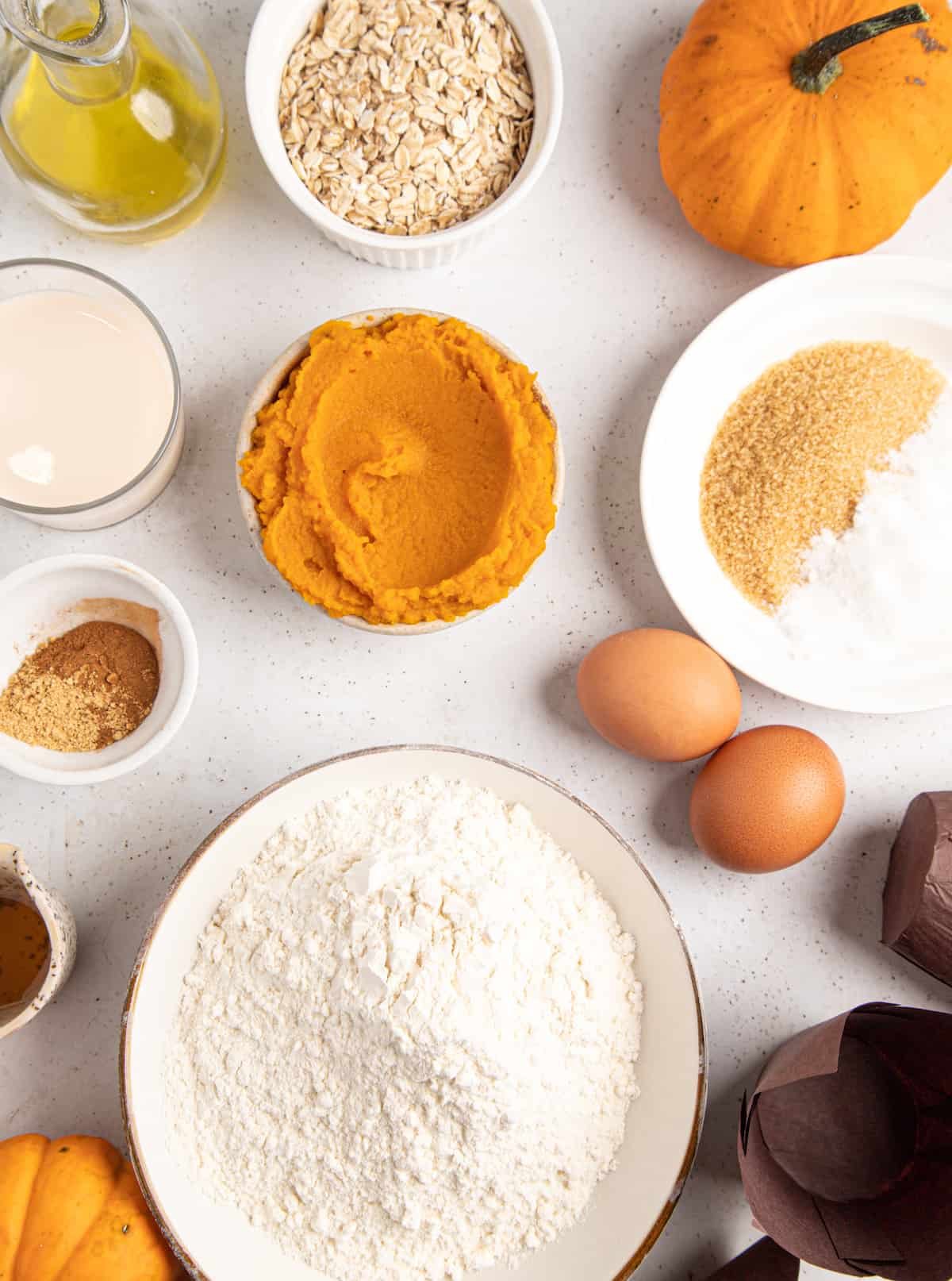 Clockwise from top: oats, sugar and leavening, eggs, flour, spices, sour cream, honey, melted butter