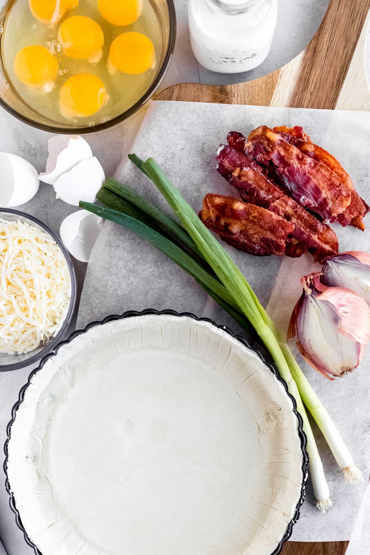 A Refrigerated Pie Crust, Bacon, Eggs, Shredded Swiss Cheese and the Remaining Quiche Ingredients