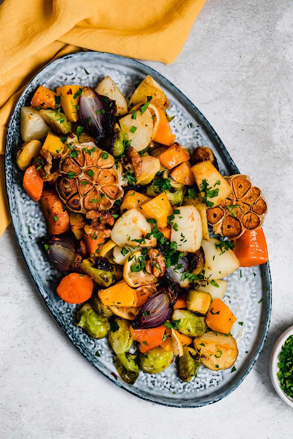 Roasted vegetables on a blue serving platter.