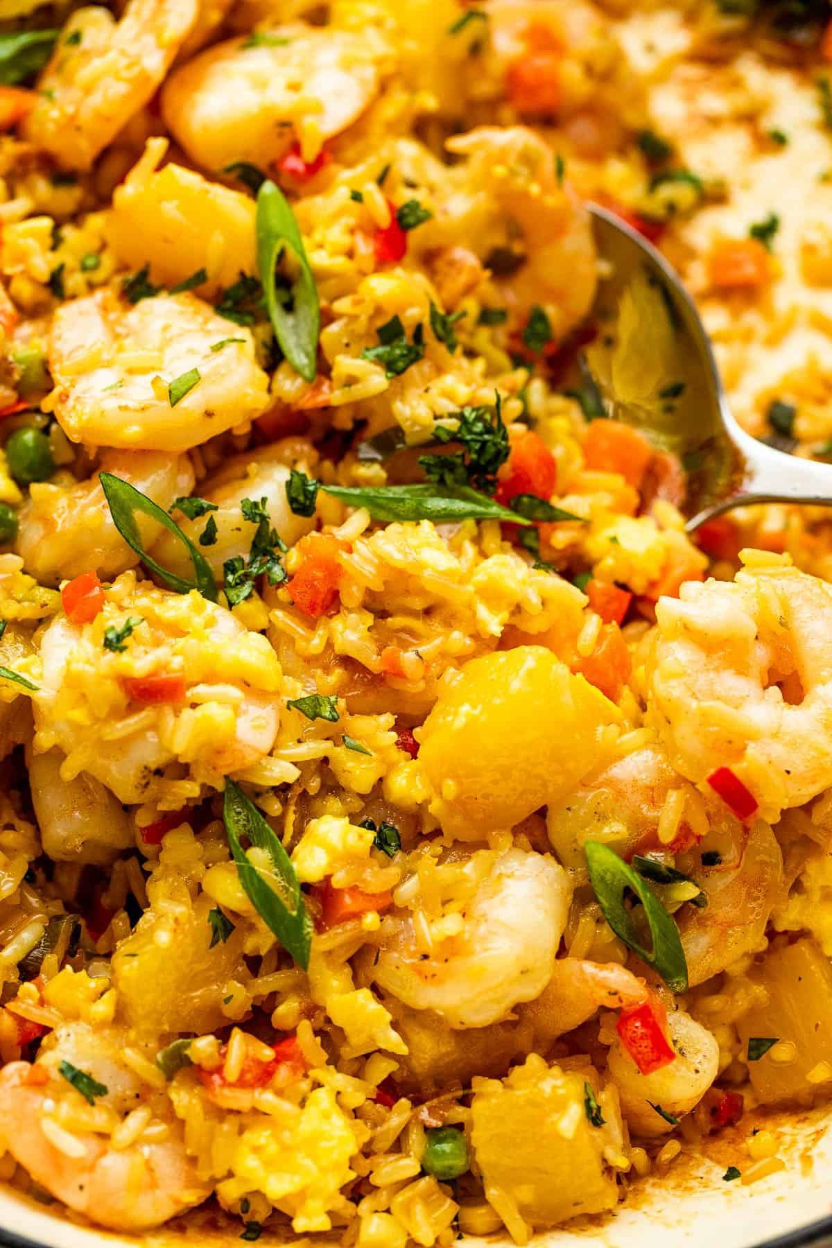 scooping out Shrimp Fried Rice with a large stainless spoon