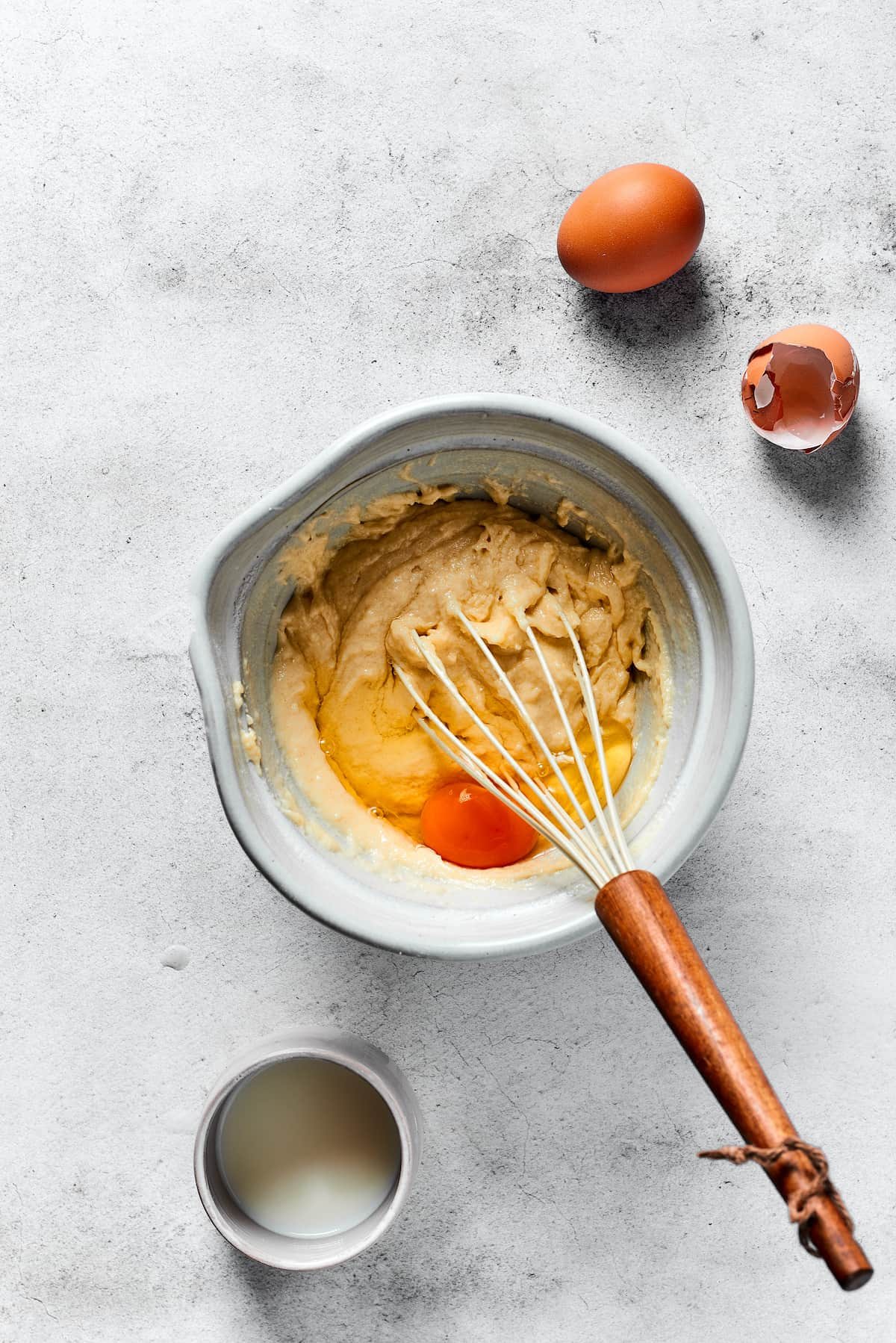 Mixing eggs and buttermilk into waffle batter.