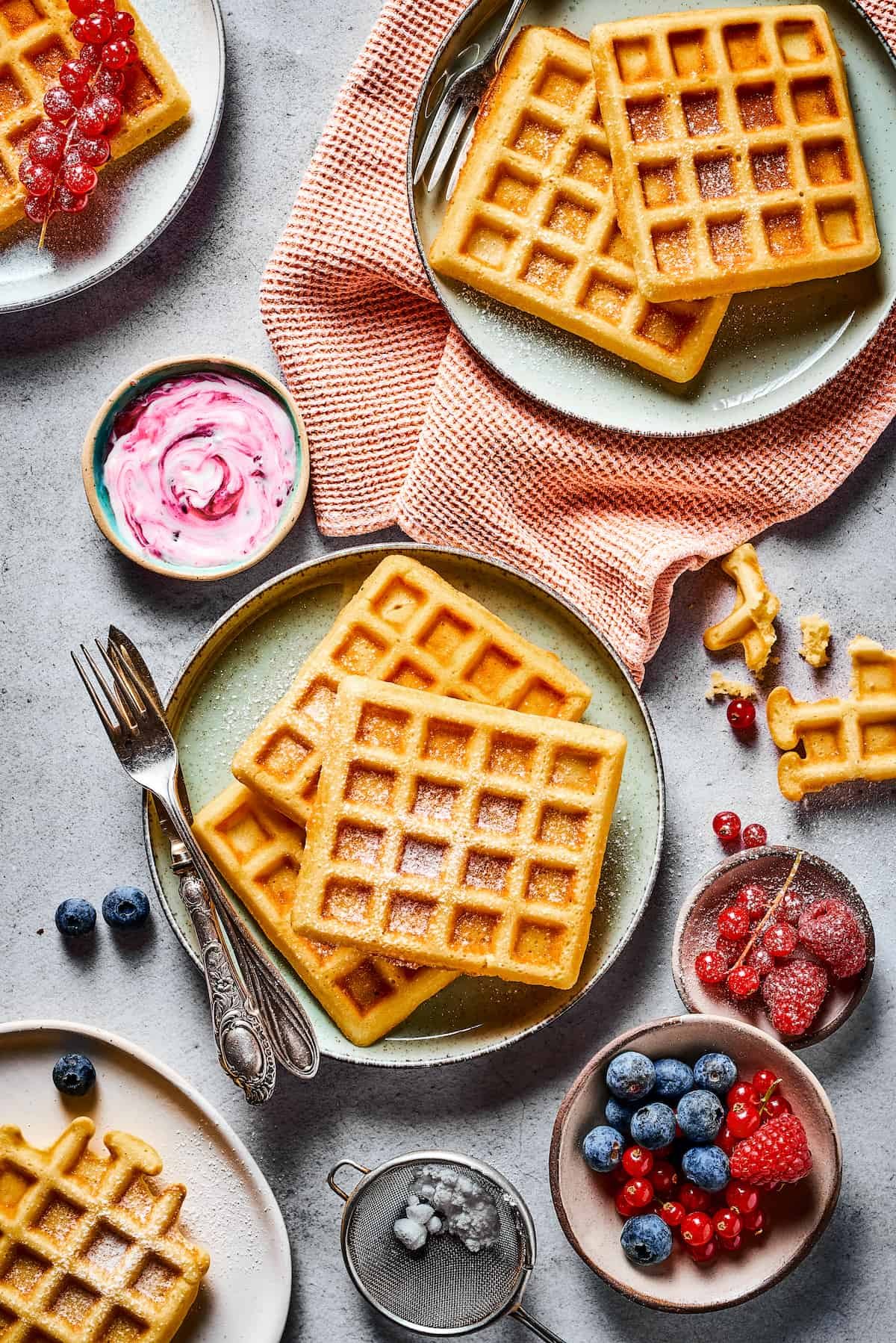 A tablescape with fresh fruit, homemade waffle recipe, and cloth napkins.