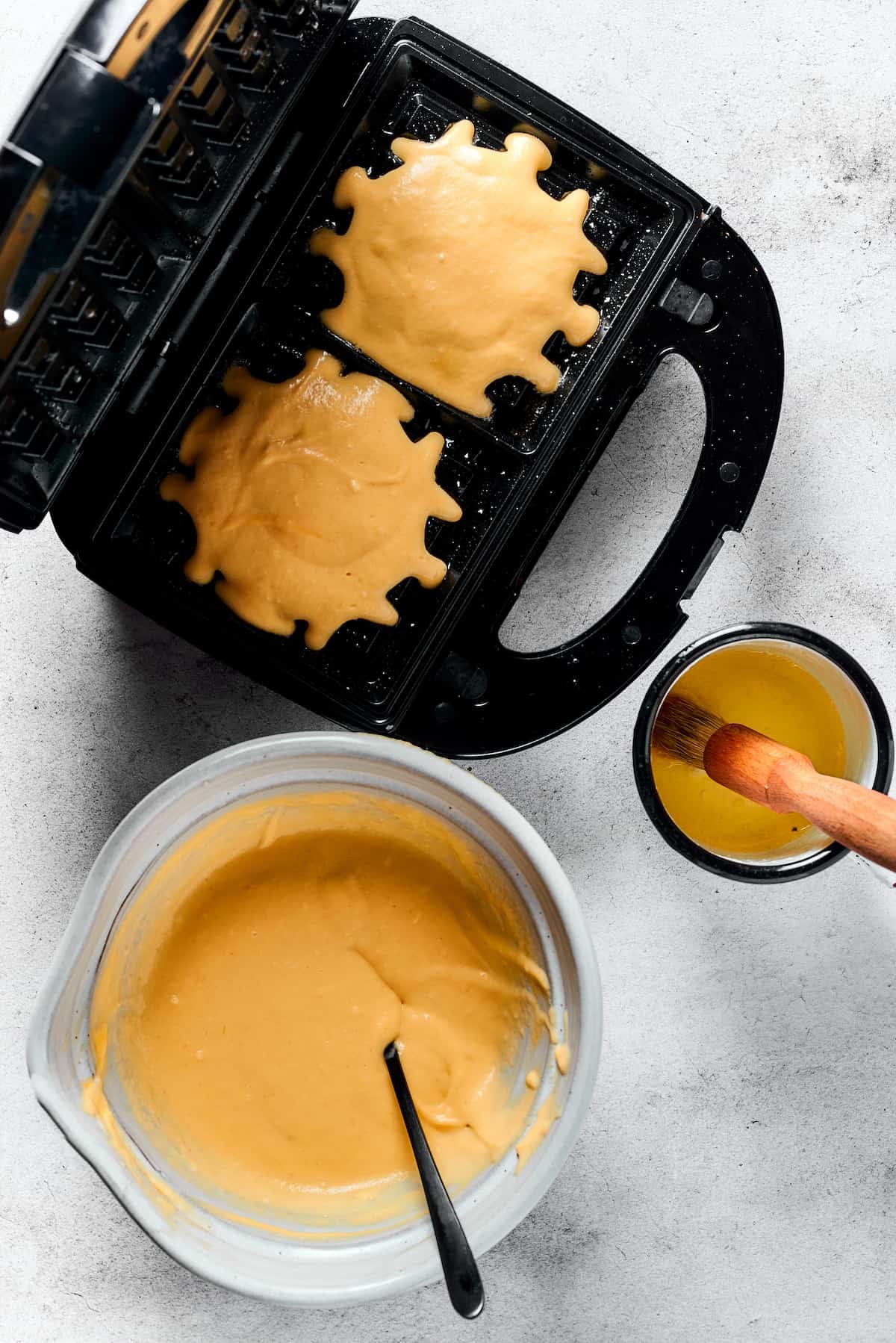 Making waffles in a waffle iron.