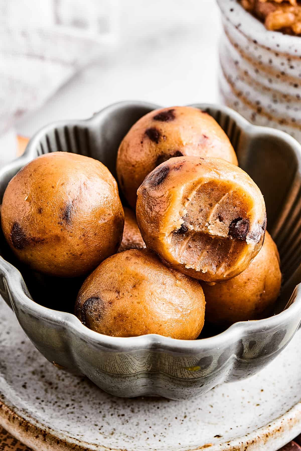 Edible cookie dough balls in a small fluted bowl.