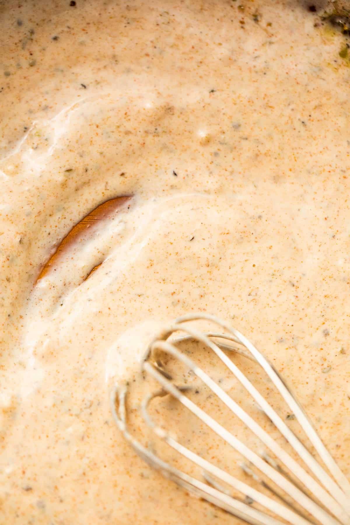 whisking creamy dressing