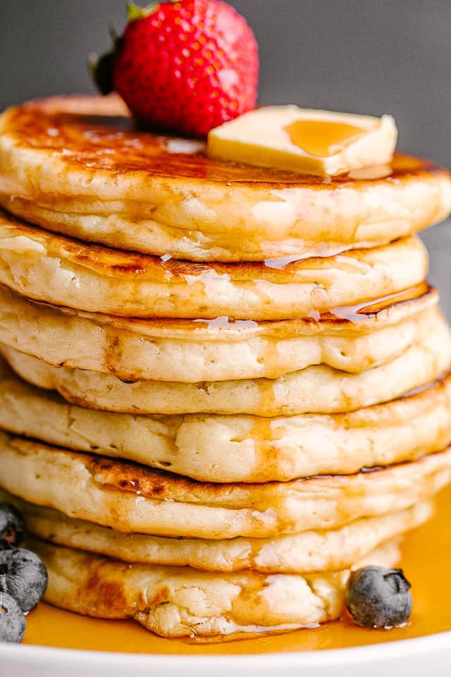 Close up of fluffy pancakes topped with fresh berries.