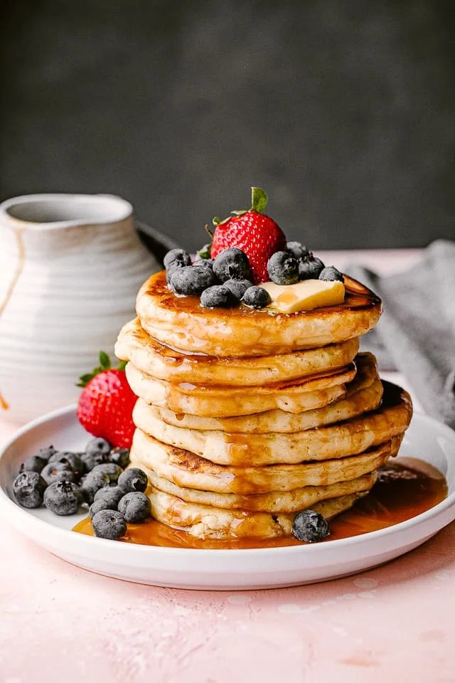 Stack of fluffy homemade pancakes from scratch