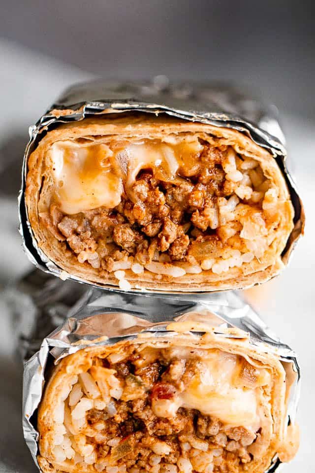 close up shot of two halved burritos stacked one on top of the other