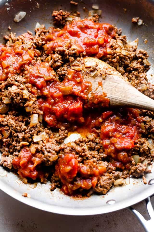 overhead shot of preparing ground beef with salsa in a skillet