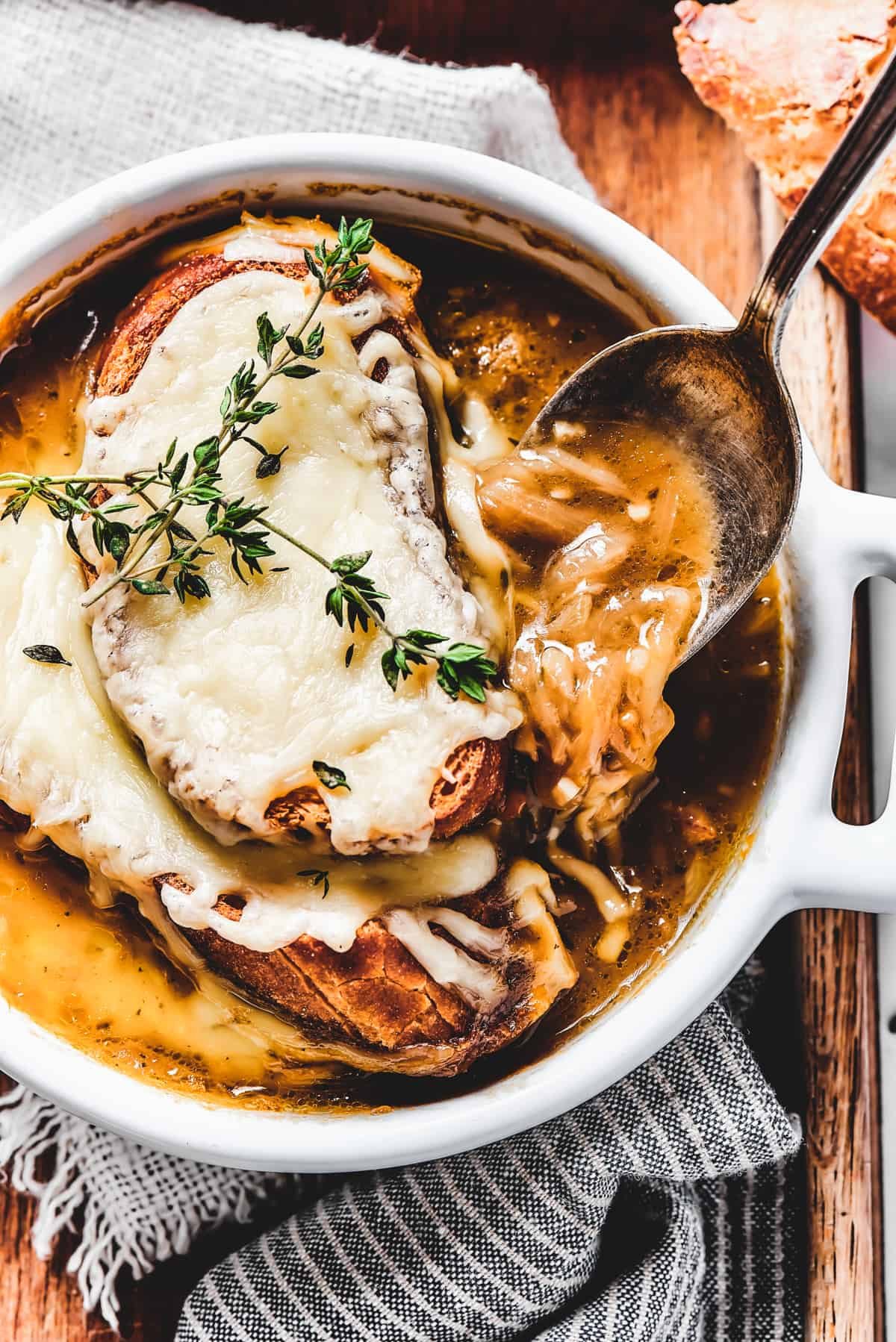 Spooning soup out of a bowl.