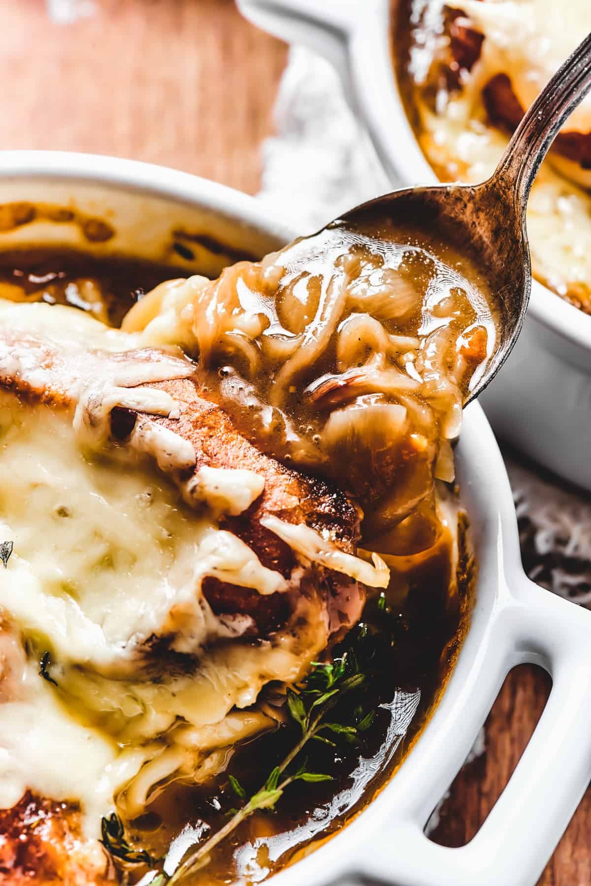 Spooning soup out of a bowl.