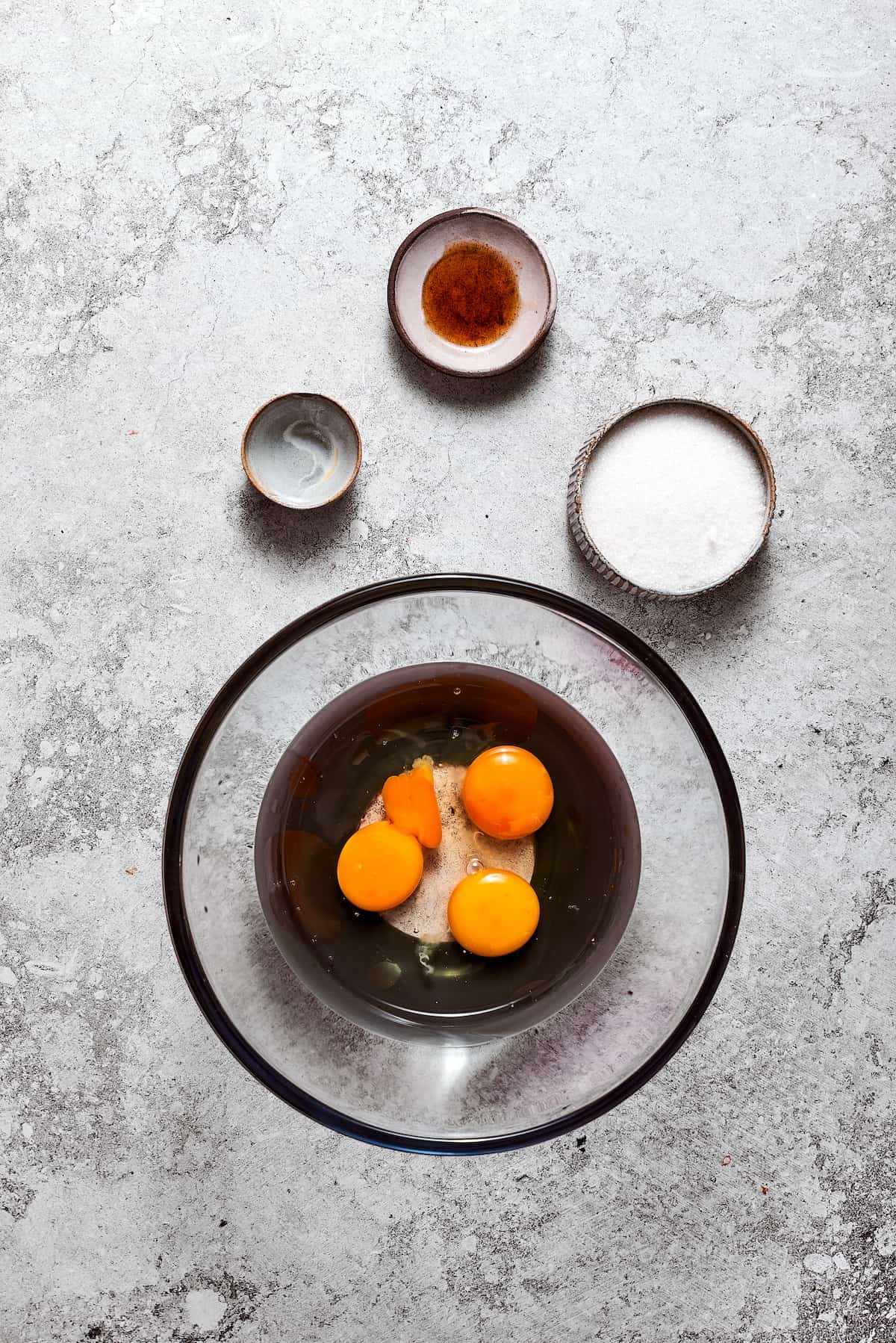 Eggs in a bowl with water and sugar.