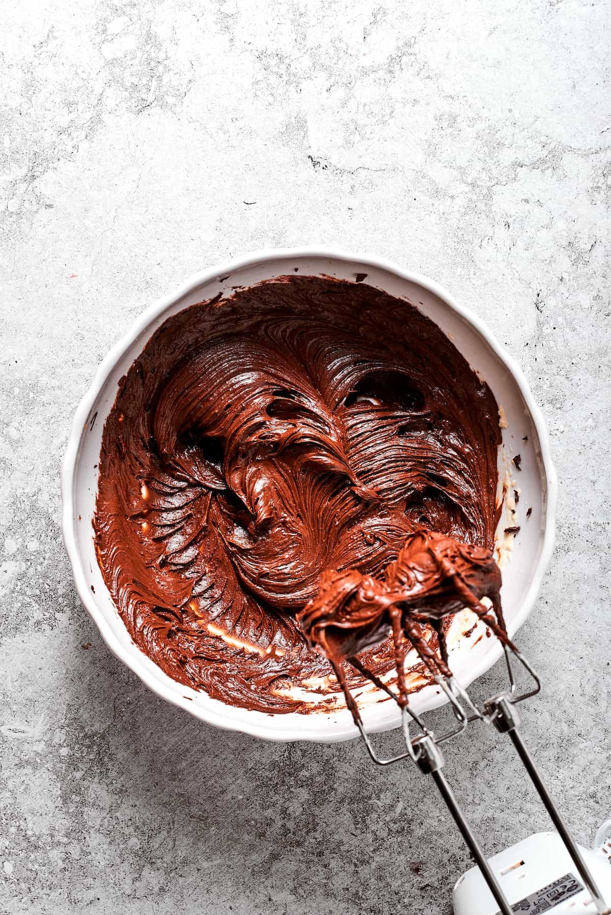 Chocolate is beaten into chocolate filling.