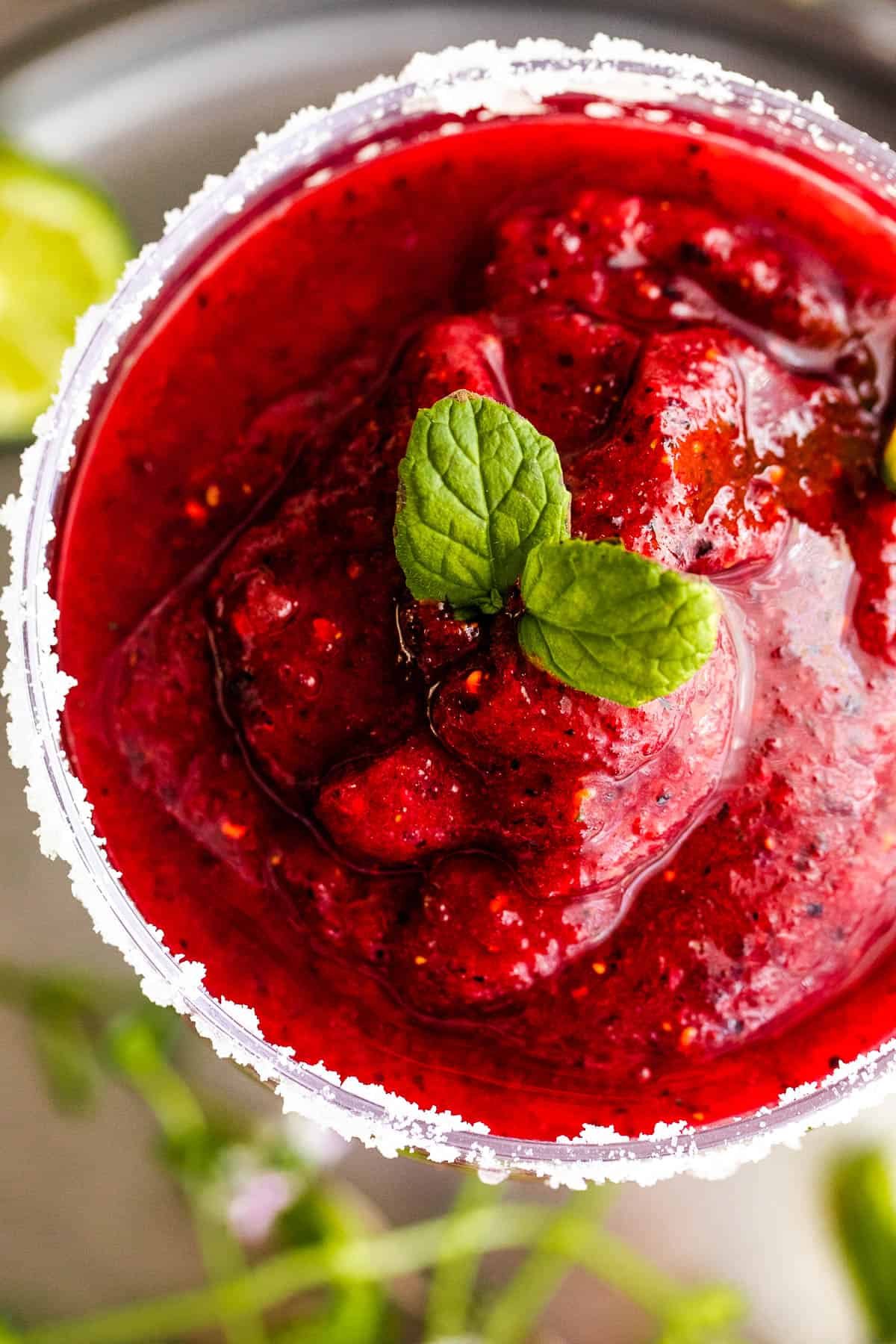 overhead close up shot of Frozen Berry Margarita served in a margarita glass and garnished with mint