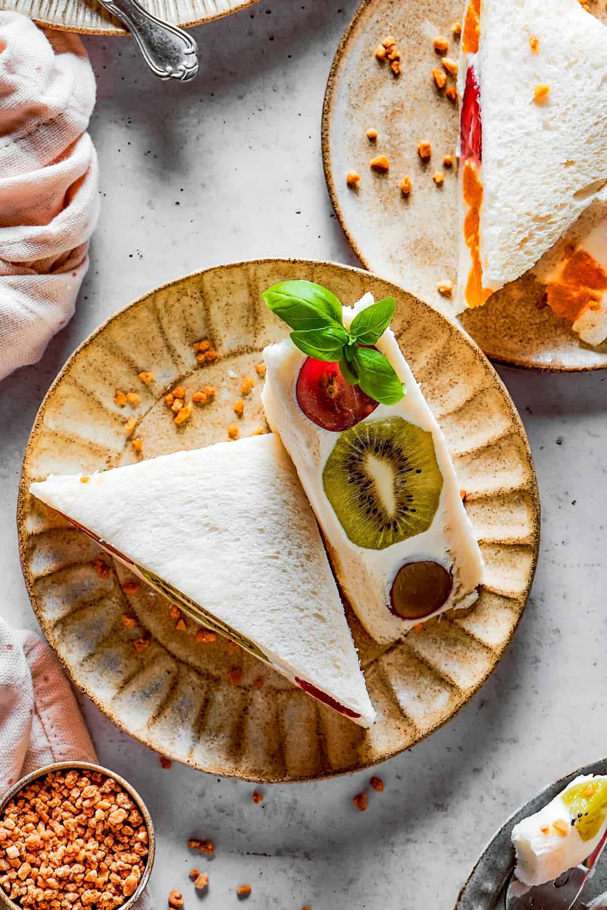 Overhead shot of fruit sandwich halves on a plate.
