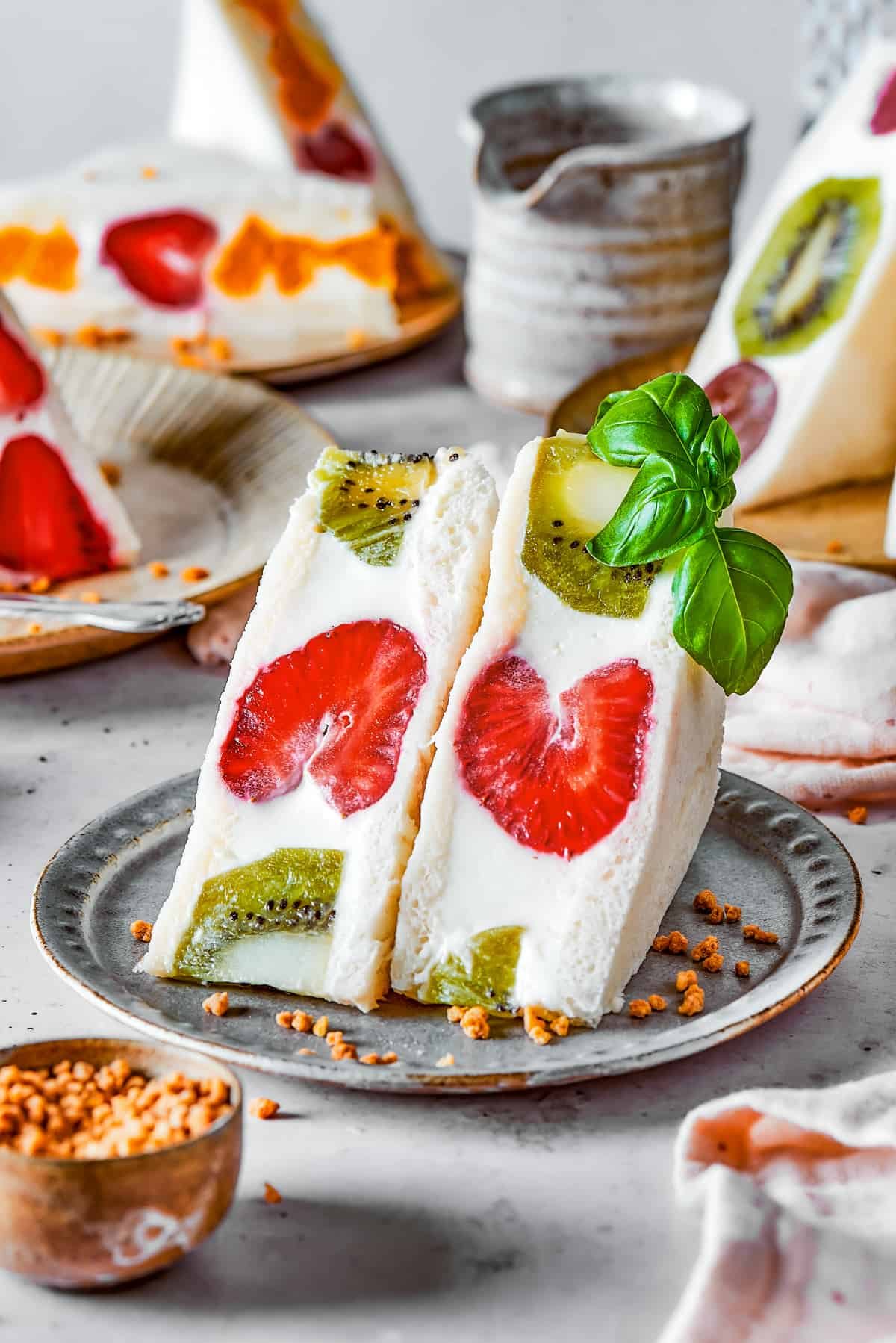 Kiwi and strawberry fruit sando on a plate.