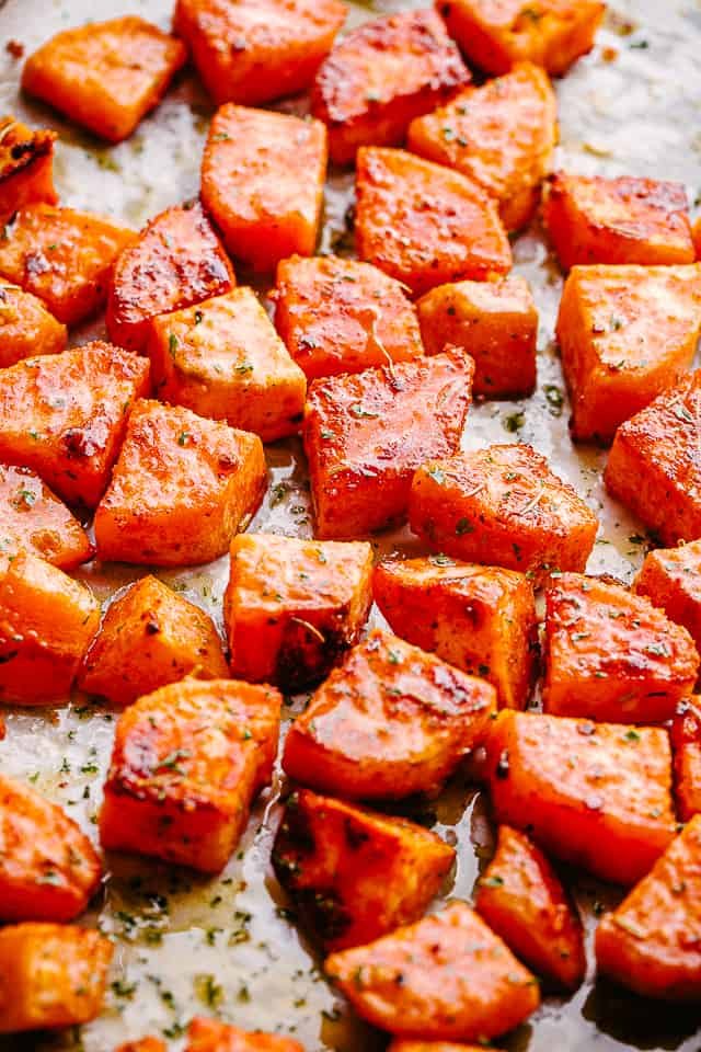 overhead shot of chopped sweet potatoes on parchment paper