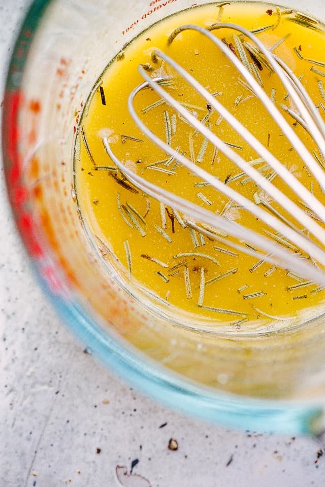 whisking sauce in a large glass cup