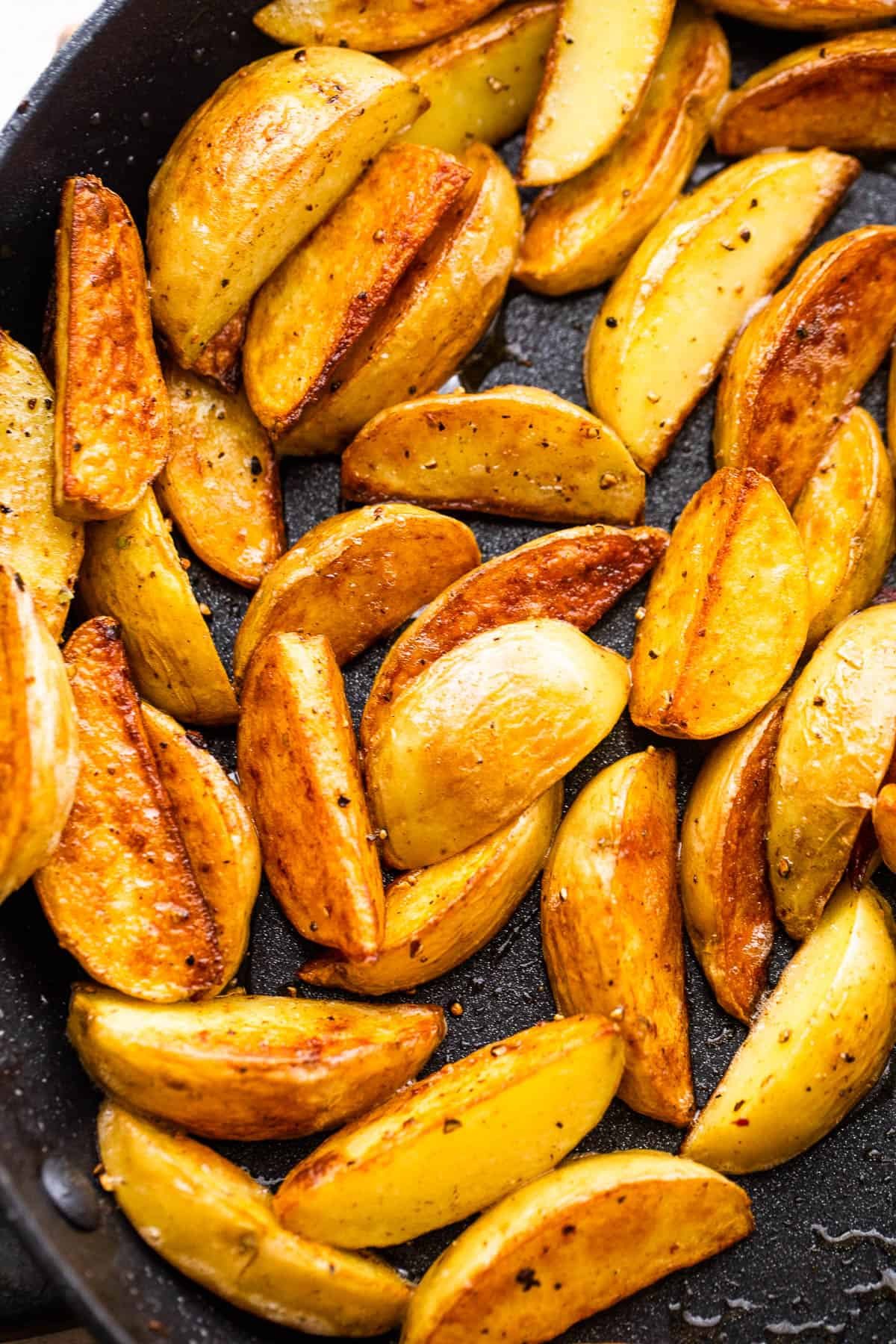 up close shot of quartered baby potatoes in a skillet