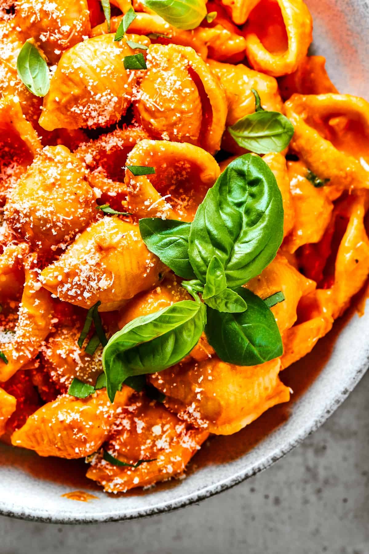 Pasta shells in creamy tomato sauce, sprinkled with parmesan.