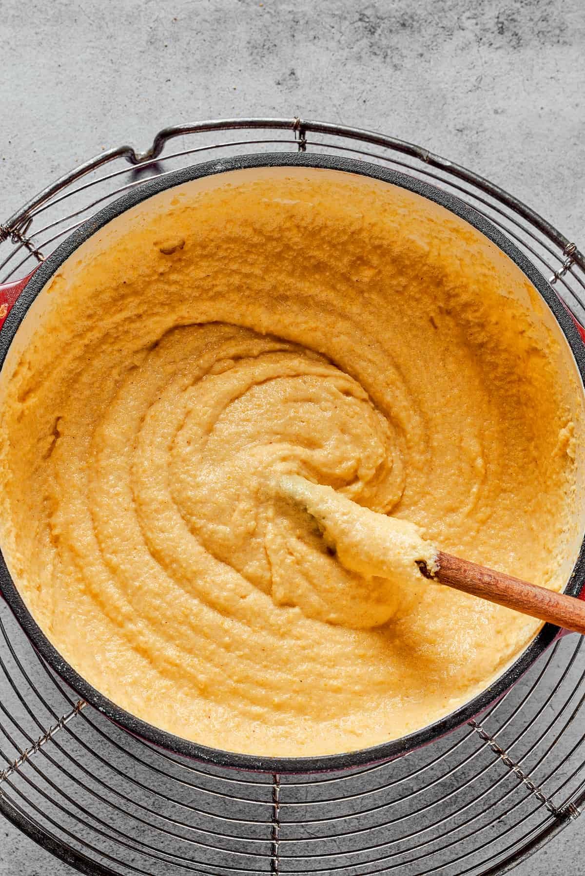 A Dutch oven filled with thick semolina batter.