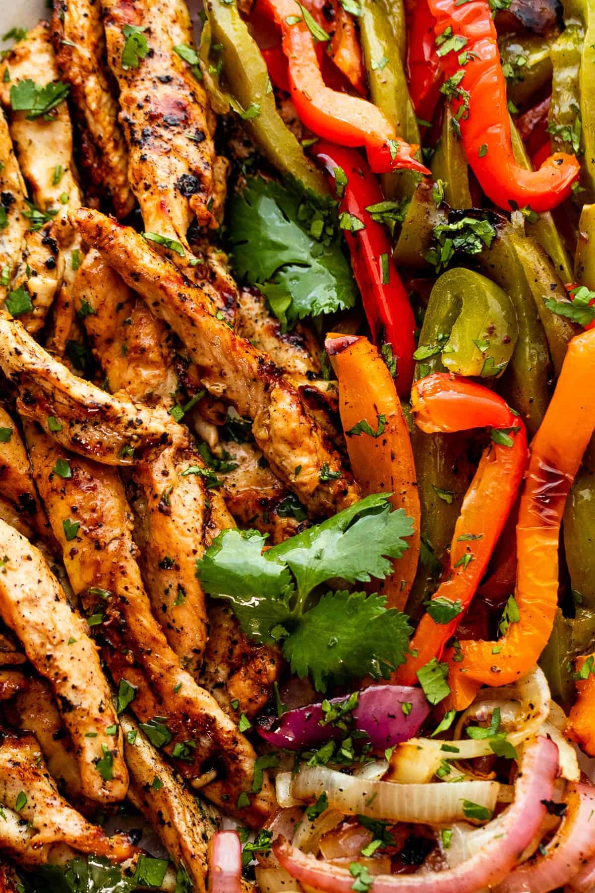 close up photo of grilled chicken and bell peppers for grilled chicken fajitas
