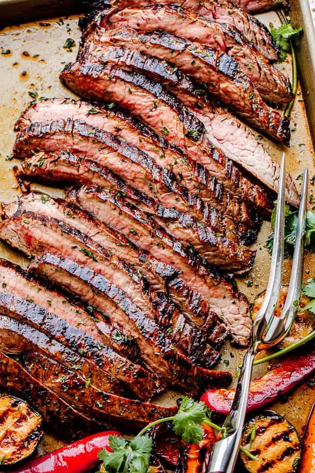 top shot of grilled steak slices with a serving fork next to it