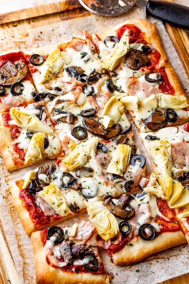 rectangular capricciosa pizza cut into squares