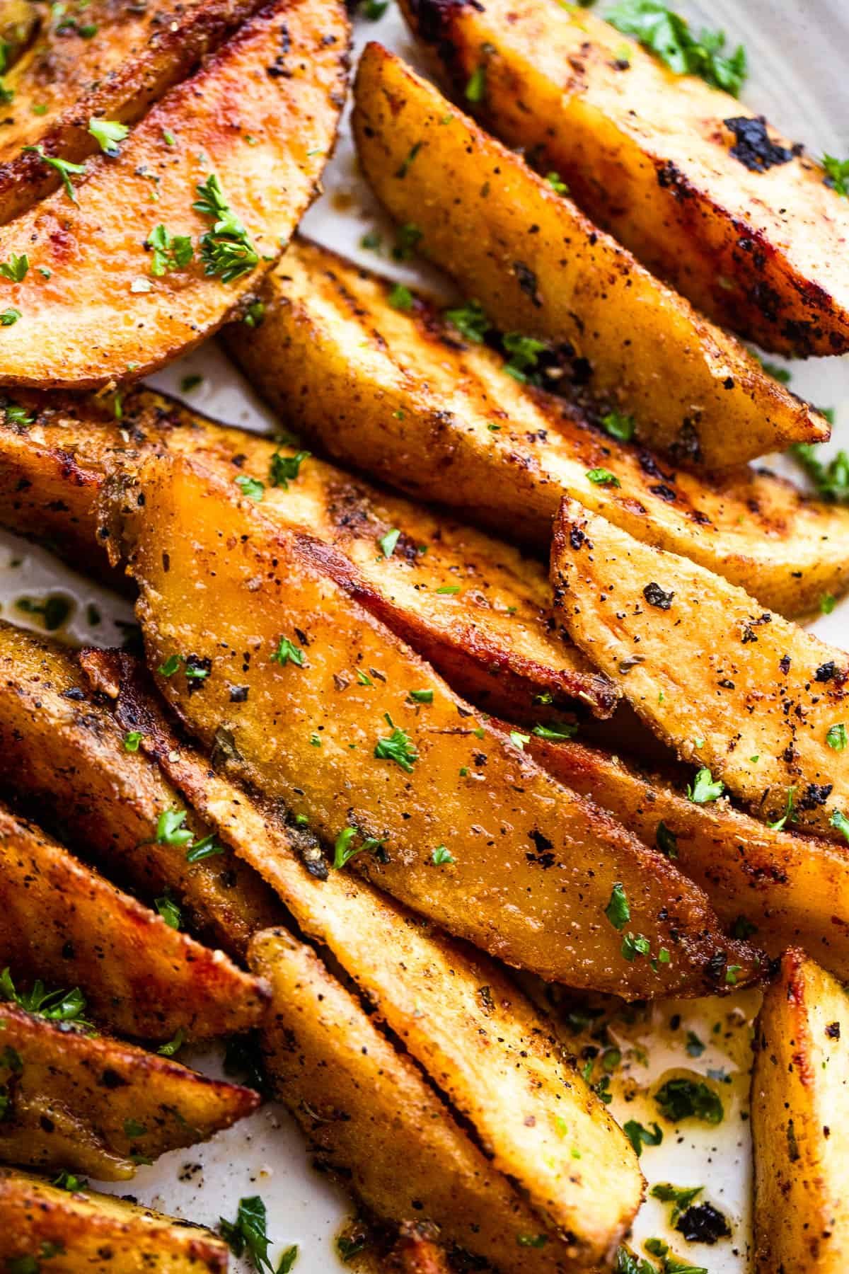 Close-up image of grilled sliced potatoes.