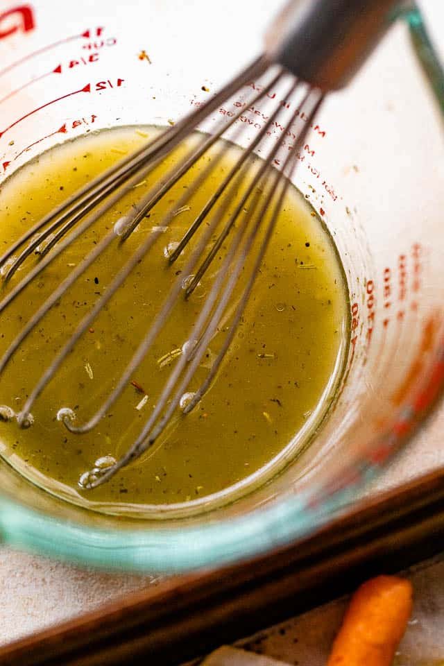 whisking homemade lemon vinaigrette