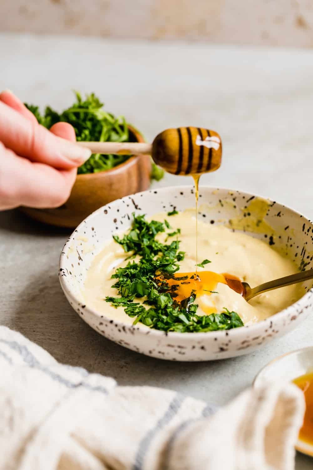 Fresh Honey Being Added to the Mayo and Parsley Mixture