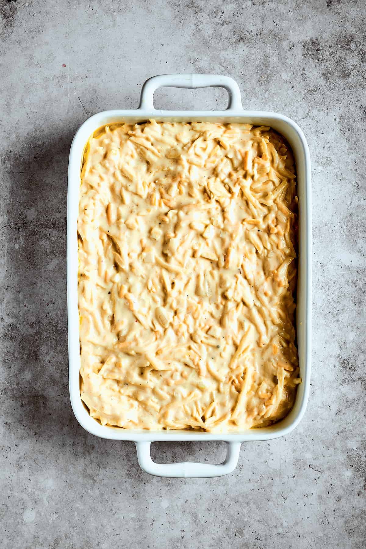 Potato mixture spread into a casserole dish.
