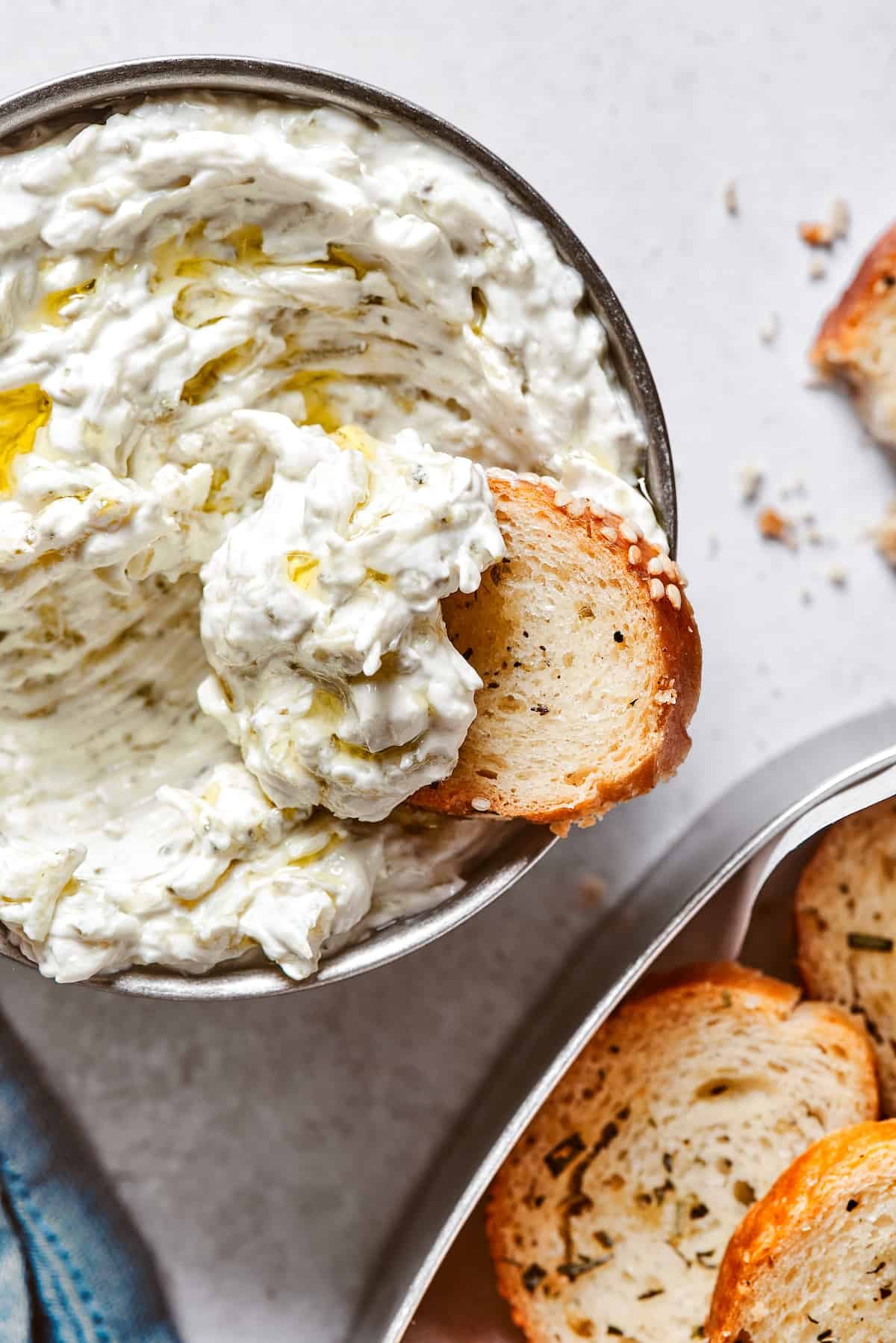 Scooping creamy dip out of a small bowl.