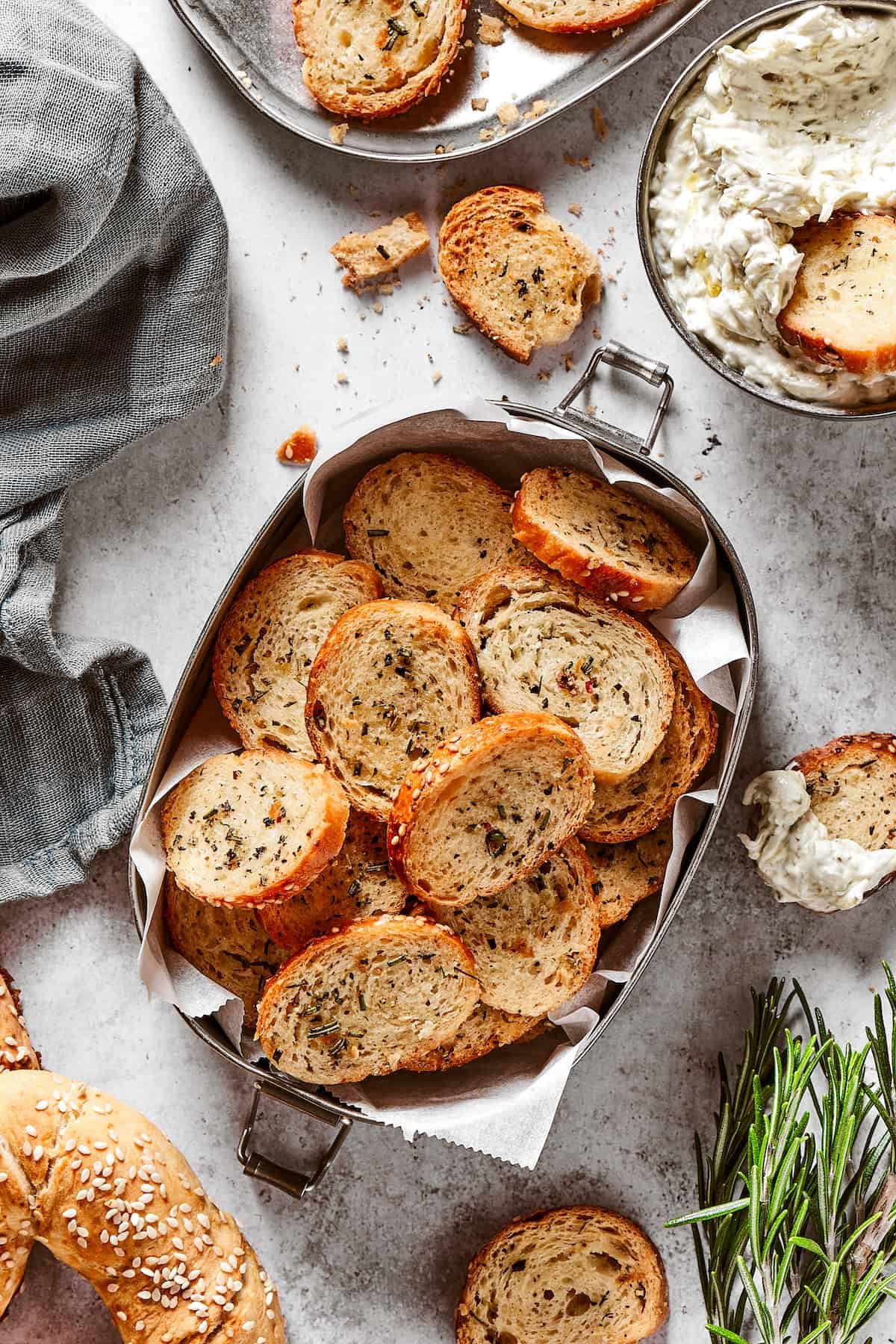 Bagel chips in a small tin lined with parchment paper.