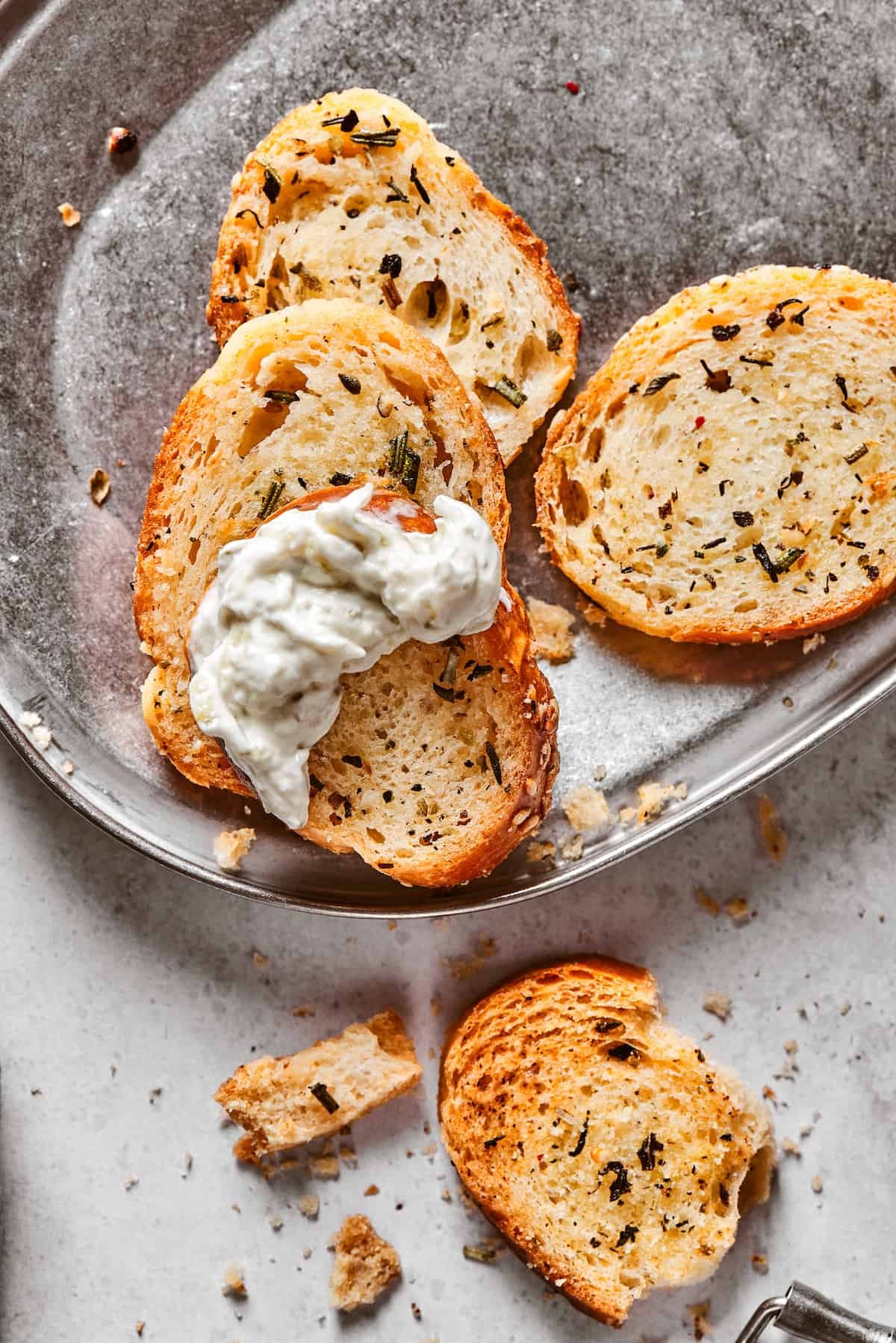 A few baked chips, one dipped in creamy dip.
