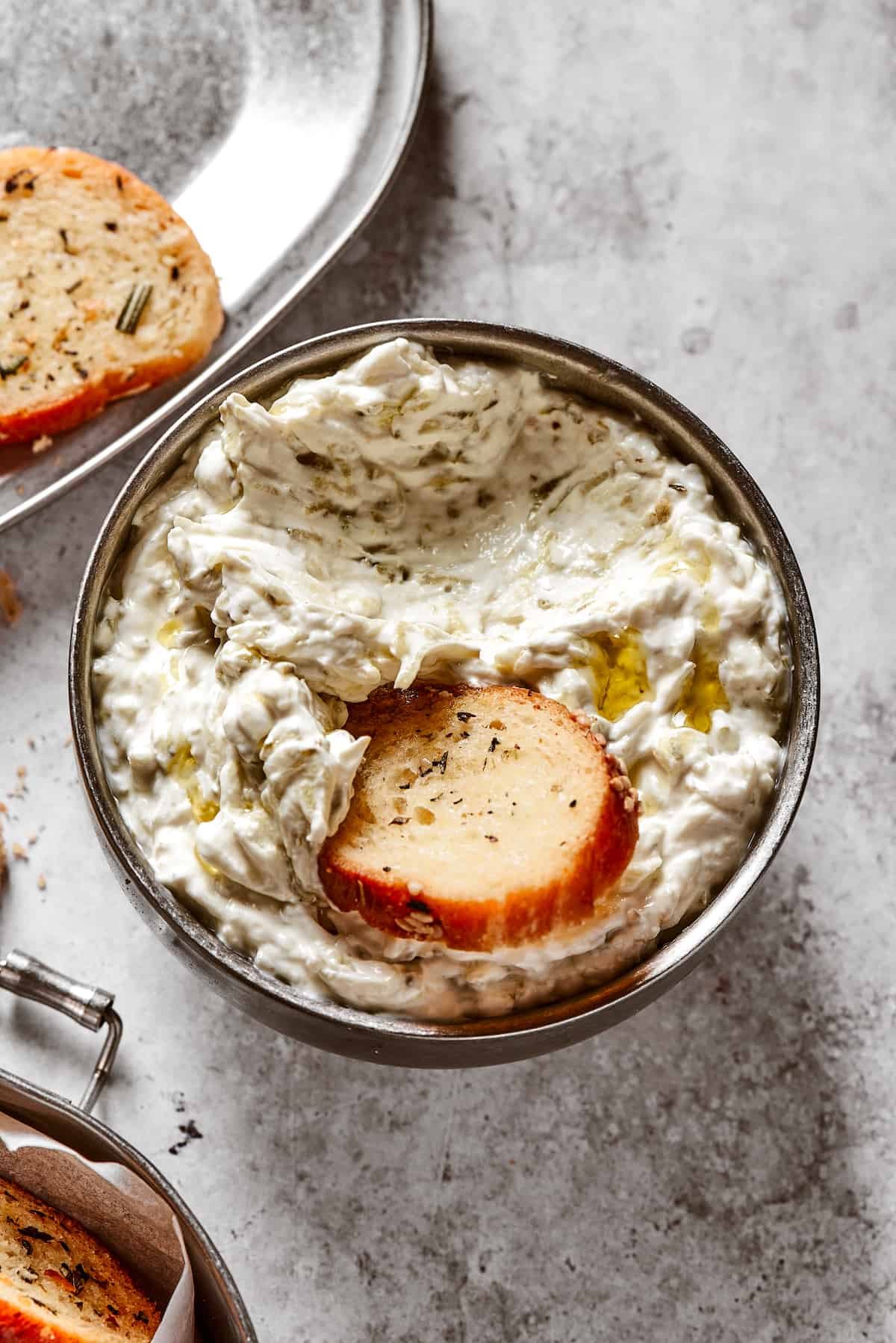 Dipping a chip into a dish of creamy dip.