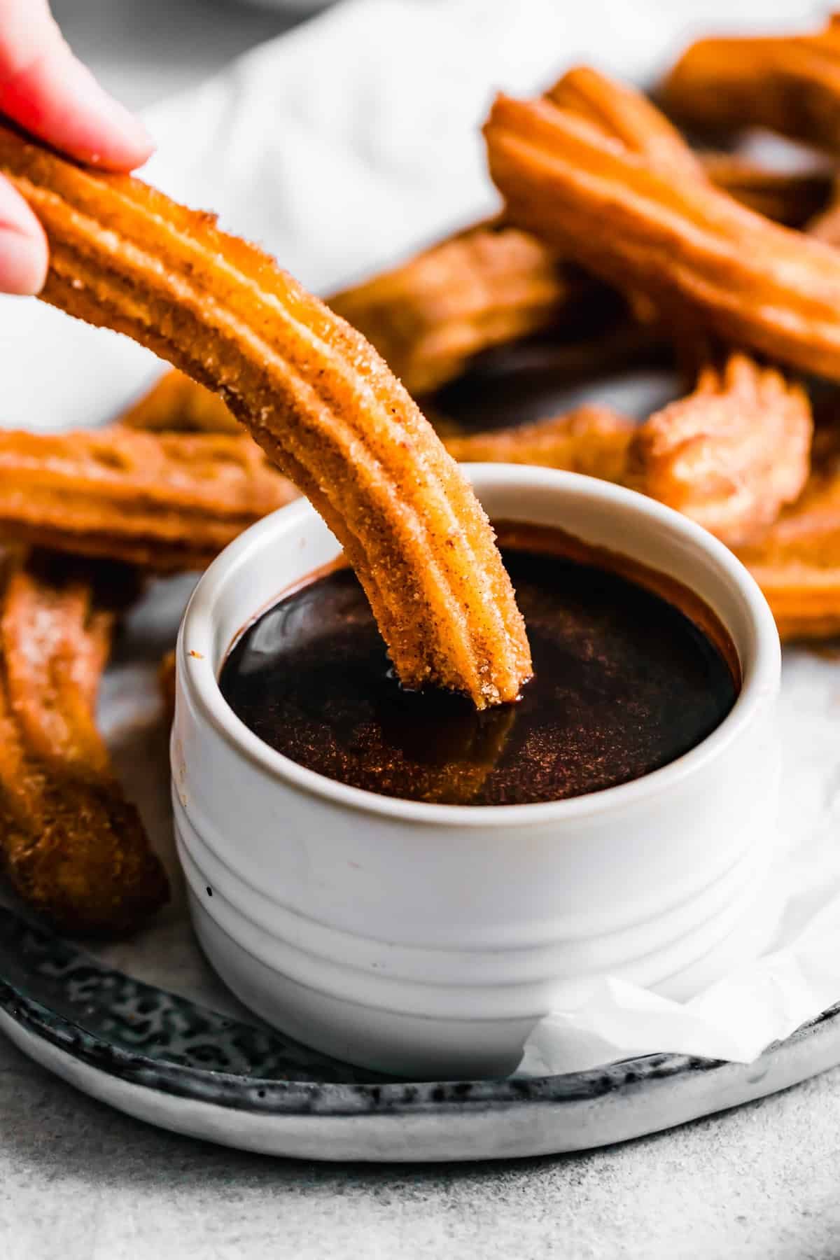 Dipping churros in chocolate sauce. Recipe by Fesuv.