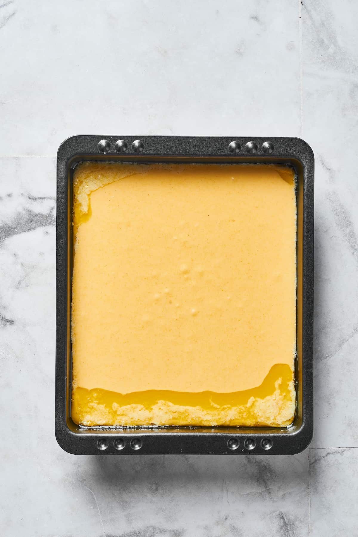 Cornmeal batter in a baking pan.