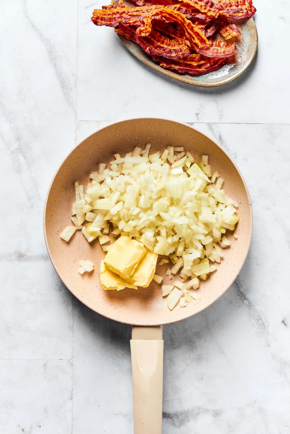 Onions and butter cooking in a skillet.