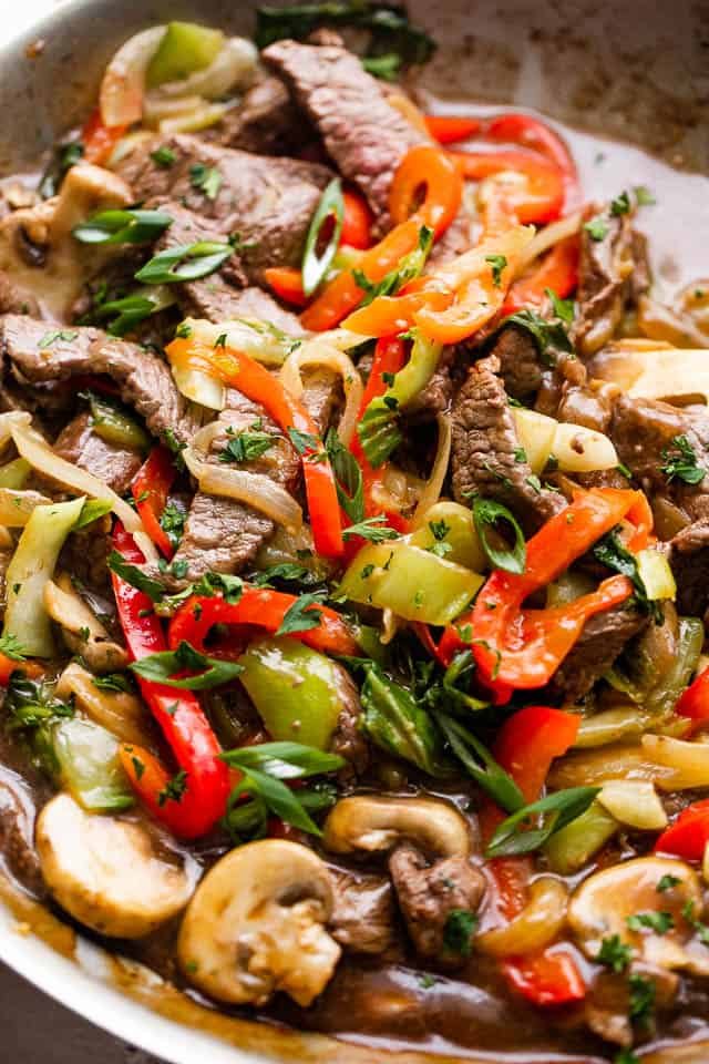 close up photo of beef stir fry with bell peppers, bok choy, mushrooms, and pepper