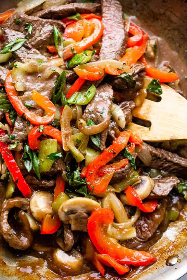 stirring through beef stir fry with vegetables