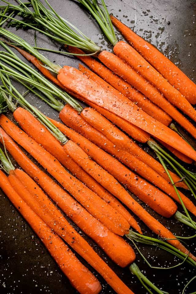 raw carrots cut in half, lengthwise