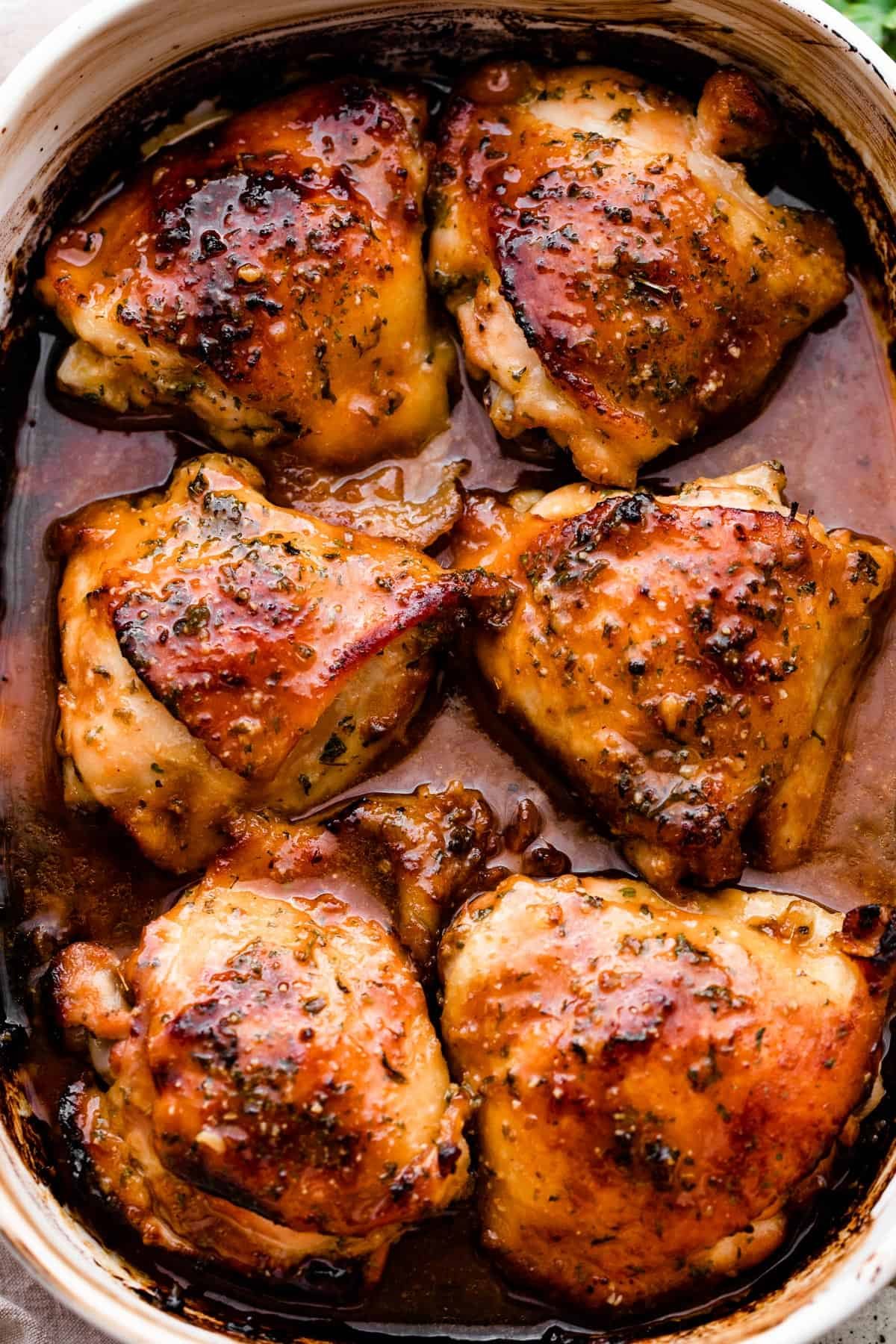 overhead shot of a baking dish with six honey garlic baked chicken thighs.
