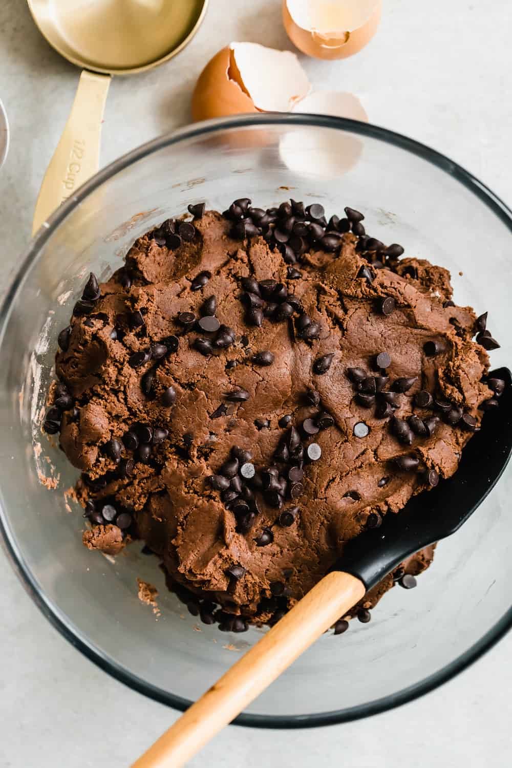 Hot Chocolate Sugar Cookie Dough with Mini Chocolate Chips and a Rubber Spatula in the Bowl