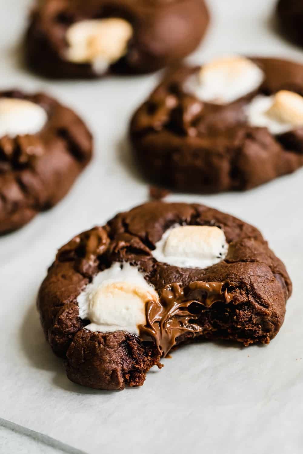 A Bitten Chocolate Sugar Cookie on a White Surface