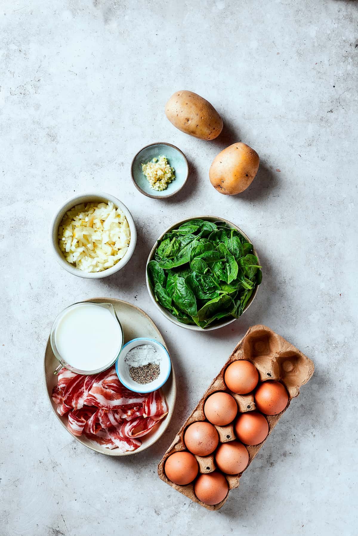 From top: Potatoes, spinach, eggs, bacon, salt and pepper, milk, onion, garlic.